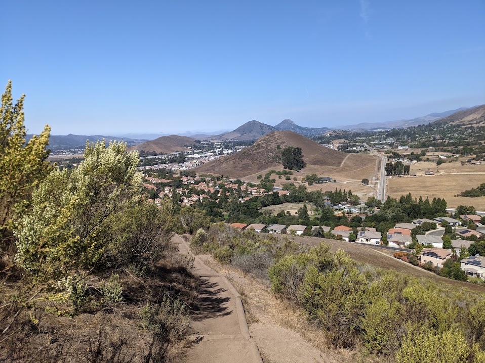 Looking out over a valley, this time with a town in it, a series of conical but isolated hills go off into the distance.