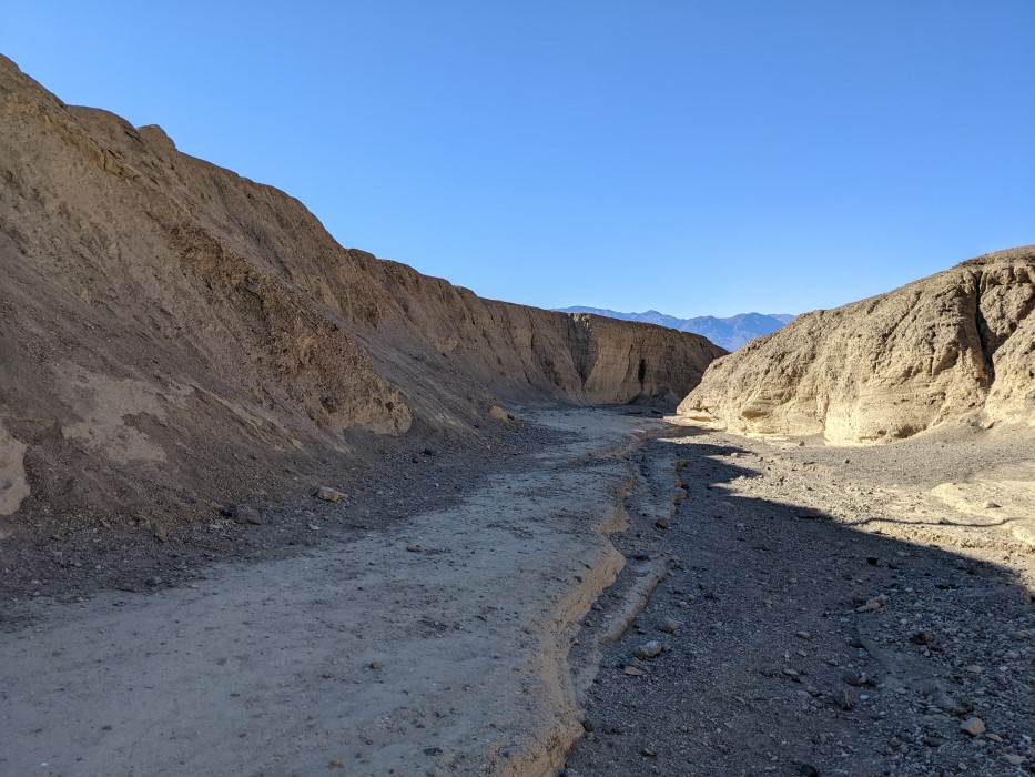 Inside the canyon, from a different angle. The walls are steep, and the bottom, only 30 or so feet across, is half stone, half dirt.